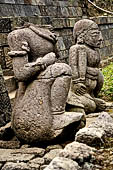 Candi Cetho - Guardians standing on the ninth terrace at the base of the staircase leading to the tenth terrace. 